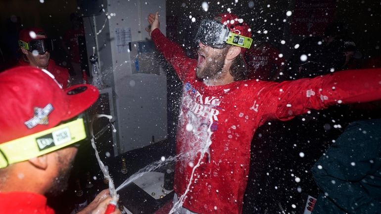 Philadelphia Phillies' Bryce Harper celebrates after winning a baseball game...