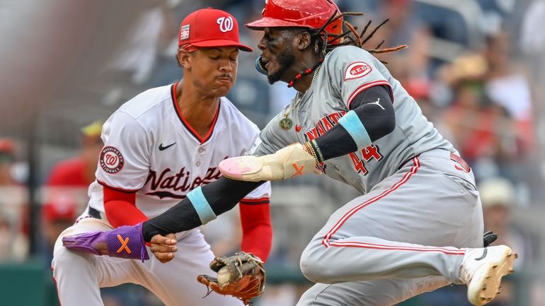 Washington Nationals third baseman Trey Lipscomb, left, tags out Cincinnati...