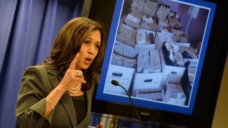 Then-California Attorney General Kamala Harris briefs the media after raids...