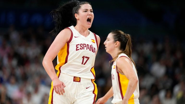 Megan Gustafson, left, of Spain, celebrates after scoring in a...