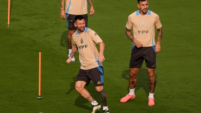 Lionel Messi, bottom left, works out with his team, Argentina,...