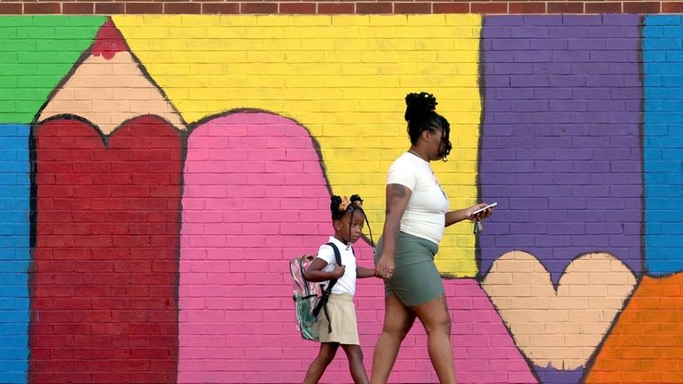 Bria Gibbs brings her daughter Tai'la Harris, 4, into Columbia...