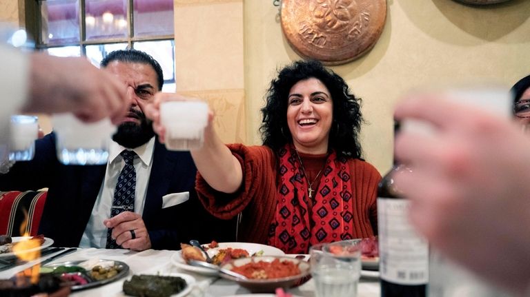 Sophia Armen, offers a toast to her colleagues, members of...