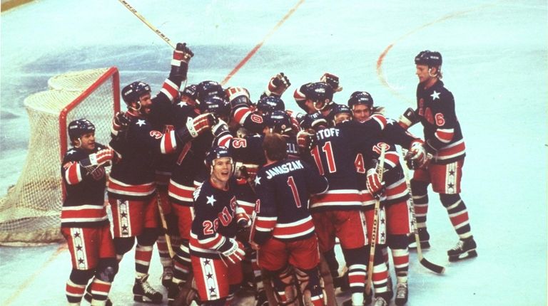 The U.S. hockey team celebrates victory over Finland to win...