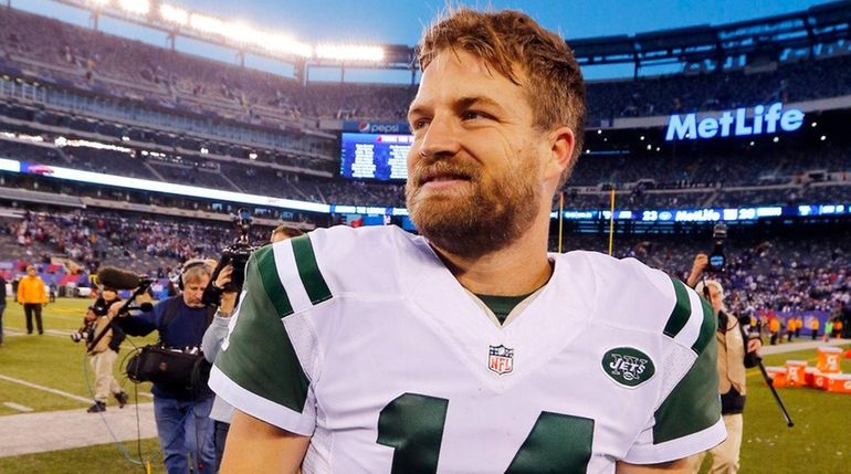 Ryan Fitzpatrick #14 of the New York Jets walks off...