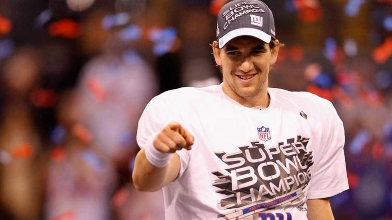 Quarterback Eli Manning of the New York Giants smiles after...