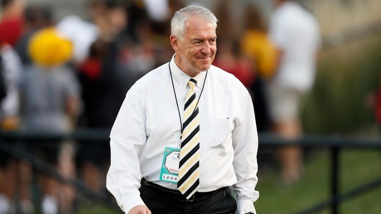 University of Iowa Athletic Director Gary Barta walks on the...