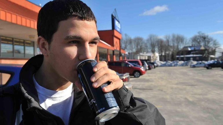 Ryan Rottkamp, 15, drinks a Monster Energy drink in West...