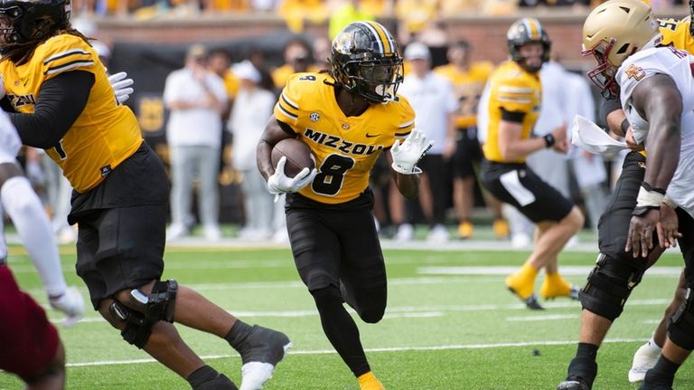 Missouri running back Nate Noel (8) scrambles for yardage during...