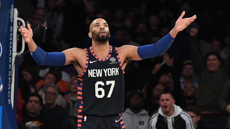 New York Knicks center Taj Gibson reacts after he dunks...