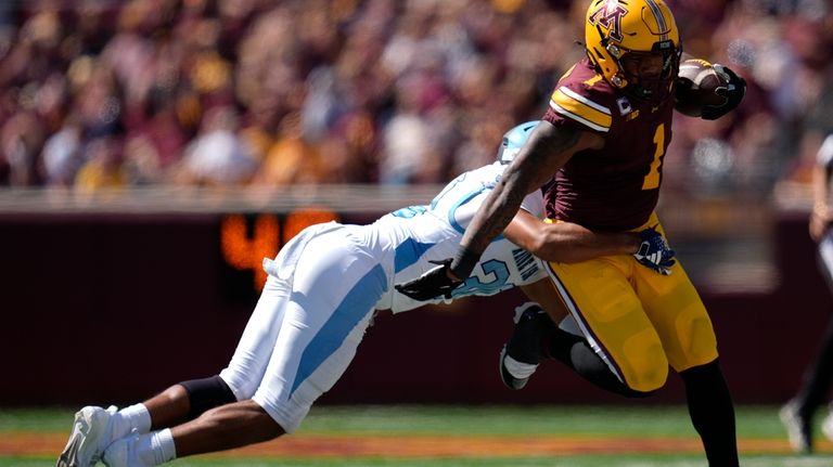 Minnesota running back Darius Taylor (1) runs with the football...