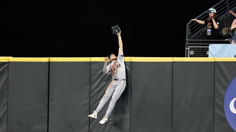 Detroit Tigers center fielder Parker Meadows leaps and catches a...