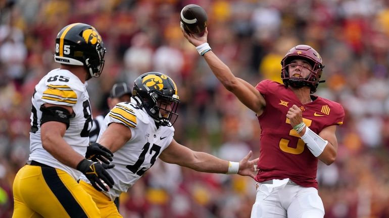 Iowa State quarterback Rocco Becht (3) passes over Iowa defensive...