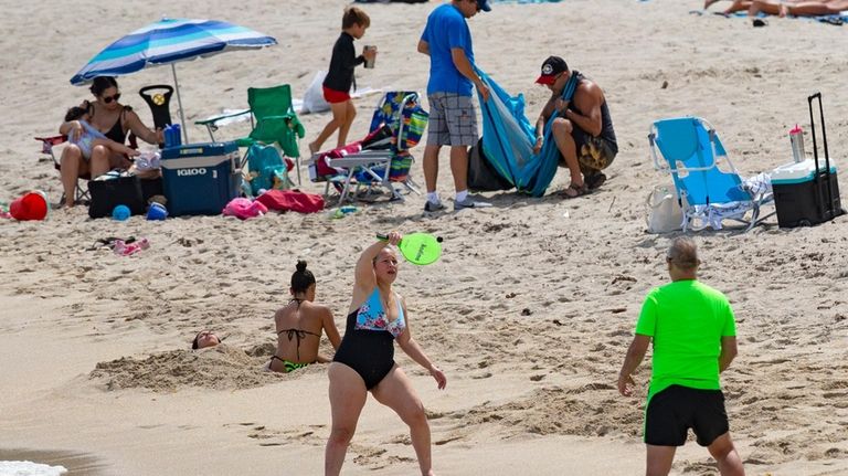 Beachgoers enjoyed the sunny and hot day at Sunny Isles...