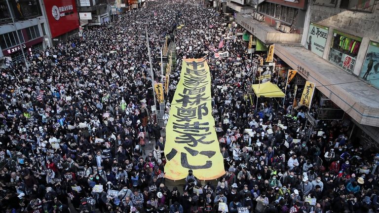 Pro-democracy protesters march on a street during a protest in...