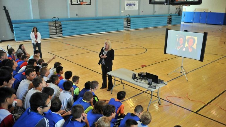 Nassau County Police Detective Pamela Stark, center, lectures youngsters on...