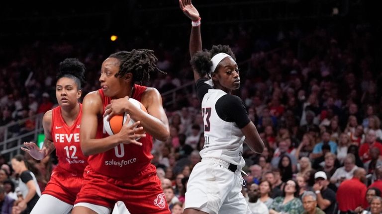 Indiana Fever guard Kelsey Mitchell (0) holds the ball against...