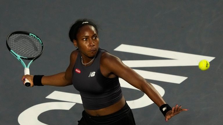 Coco Gauff of the United States returns a shot to...