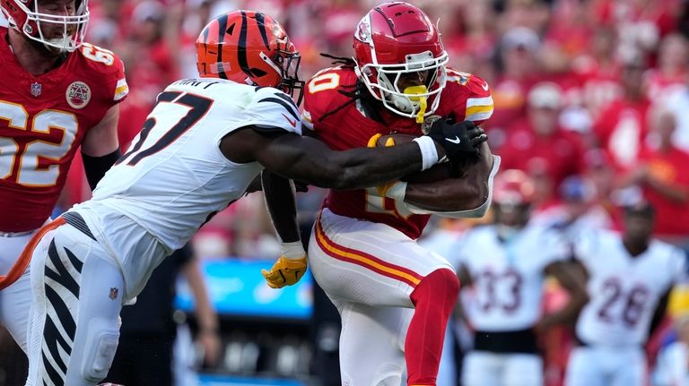 Kansas City Chiefs running back Isiah Pacheco, right, runs with...