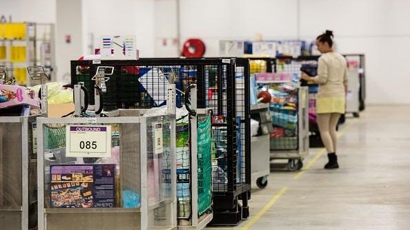 An Amazon employee works in a logistic site of the...