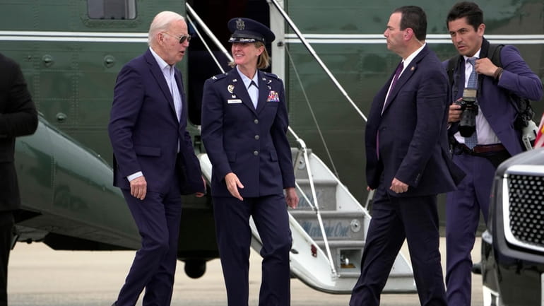 President Joe Biden talks with Air Force Col. Angela Ochoa,...