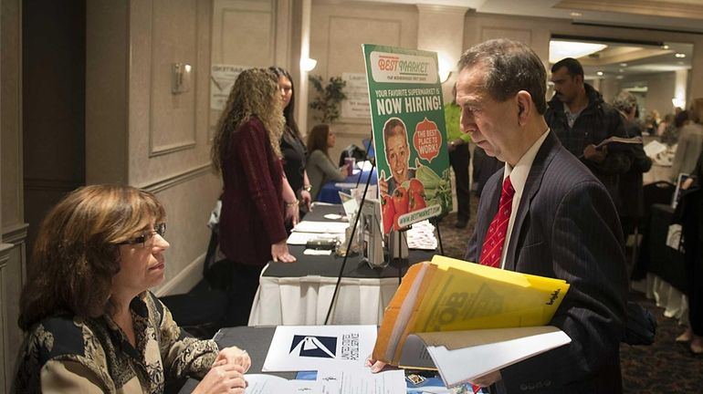 Job seeker John Keenan of Oceanside talks with U.S. Post...