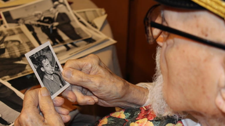 Pearl Harbor survivor Ira "Ike" Schab, 103, looks at an...