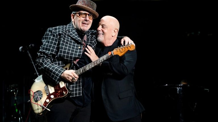 Elvis Costello pumps it up with Joel.