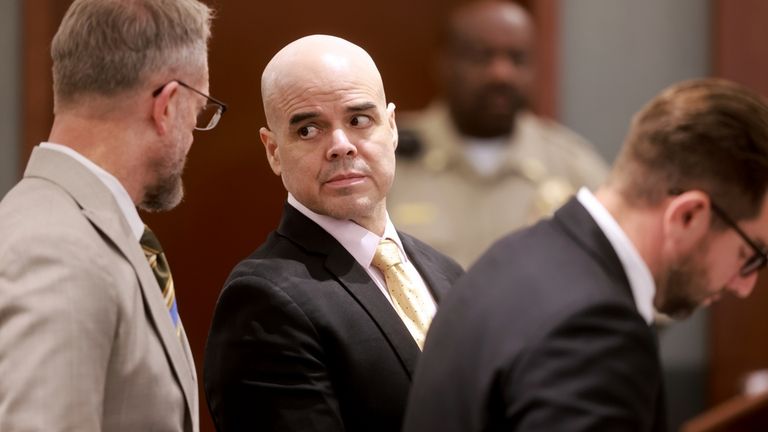 Robert Telles, center, is flanked by his attorneys Robert Draskovich,...