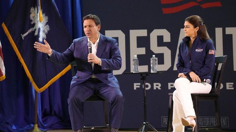 Florida Gov. Ron DeSantis, left, speaks during an event for...