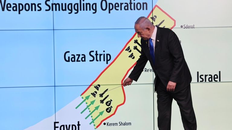 Israeli Prime Minister Benjamin Netanyahu gestures in front of a...