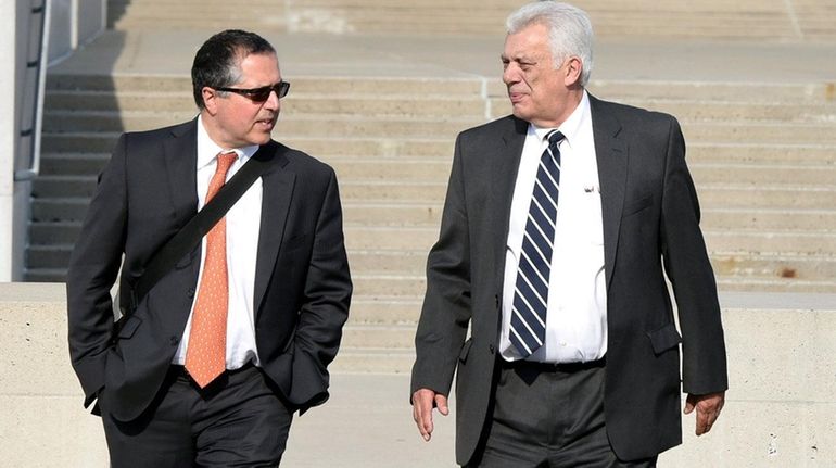 Attorney Marc Agnifilo, left, walks out of federal court in...