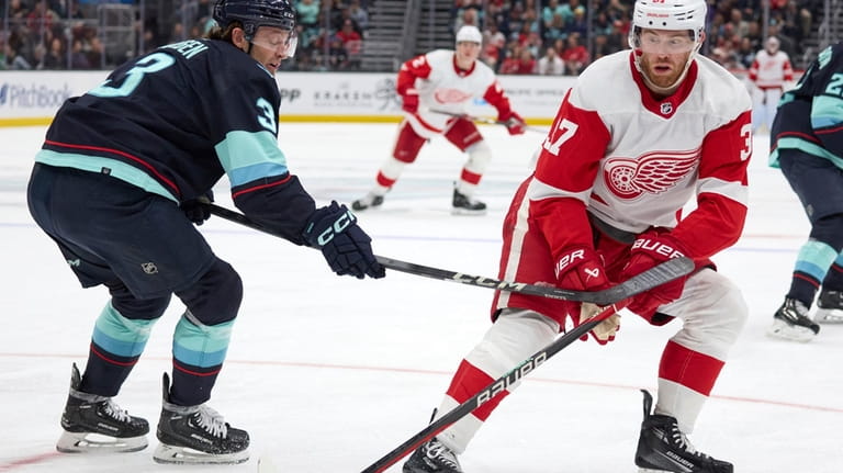 Detroit Red Wings right wing Daniel Sprong works to control...