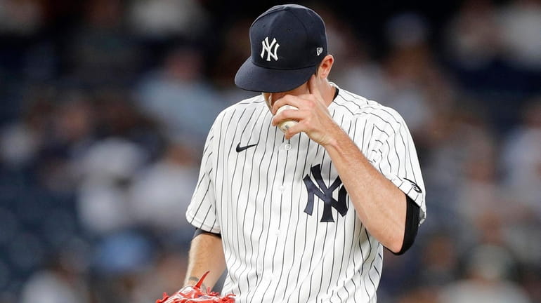 Andrew Heaney of the New York Yankees reacts on the...