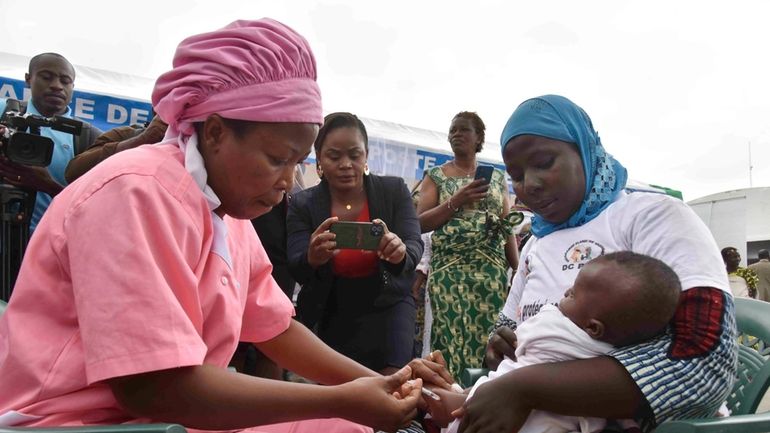 A health worker administers the malaria vaccine Oxford-Serum R21 to...