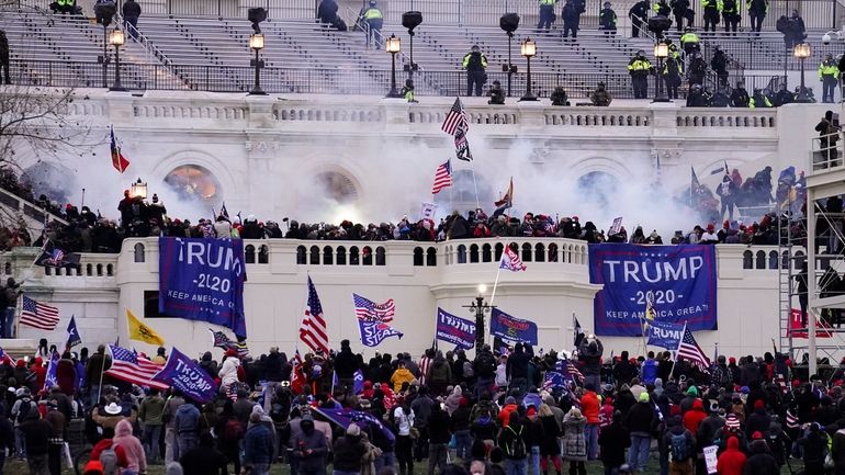 Violent protesters, loyal to President Donald Trump, storm the Capitol,...