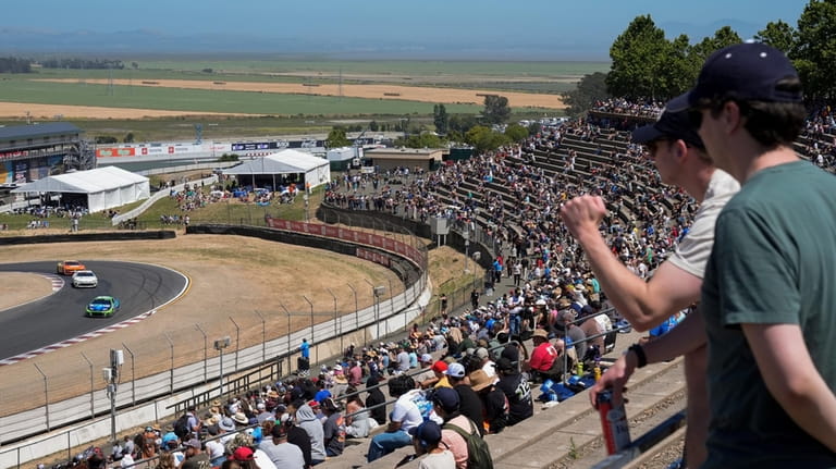Fans watch a NASCAR Cup Series auto race at Sonoma...