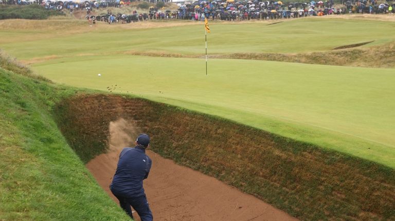 Shane Lowry of Ireland plays from a bunker on the...