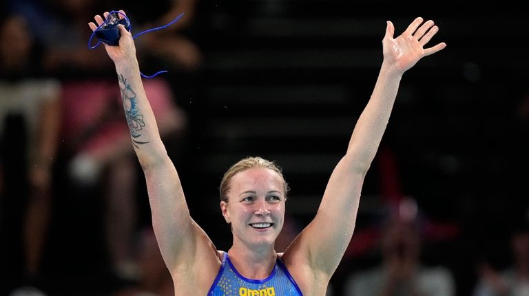 Sweden's Sarah Sjoestroem celebrates after winning the gold medal in...