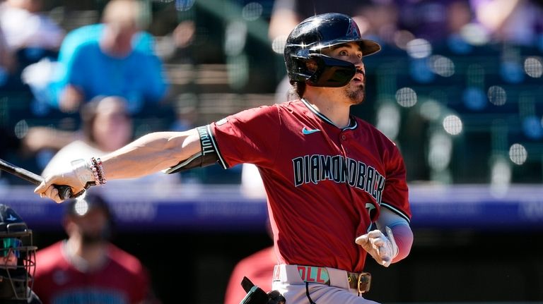 Arizona Diamondbacks' Corbin Carroll follows the flight of his two-run...