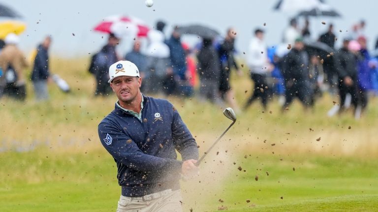 Bryson DeChambeau of the United States plays out of a...