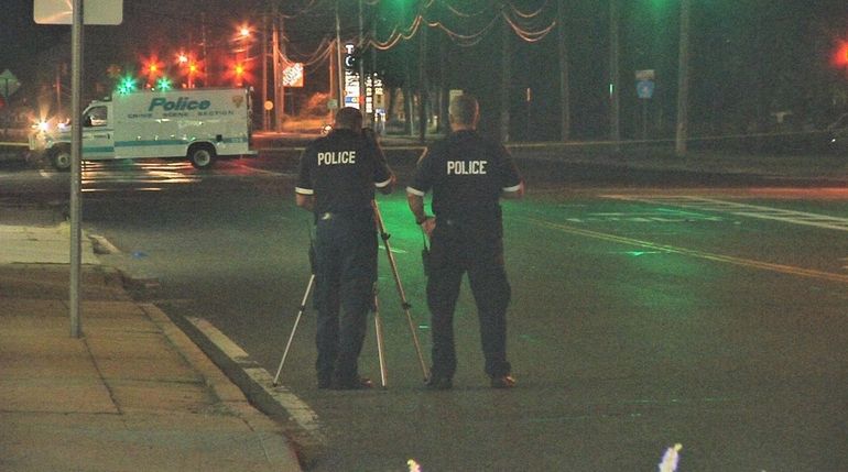 Suffolk County police investigate an accident scene at Commack Road...