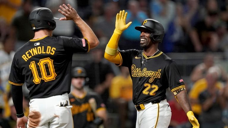 Pittsburgh Pirates' Andrew McCutchen, right, is greeted by Bryan Reynolds,...