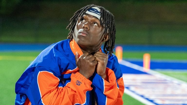 Malverne's Josiah Brown stands with crutches on the sideline against...