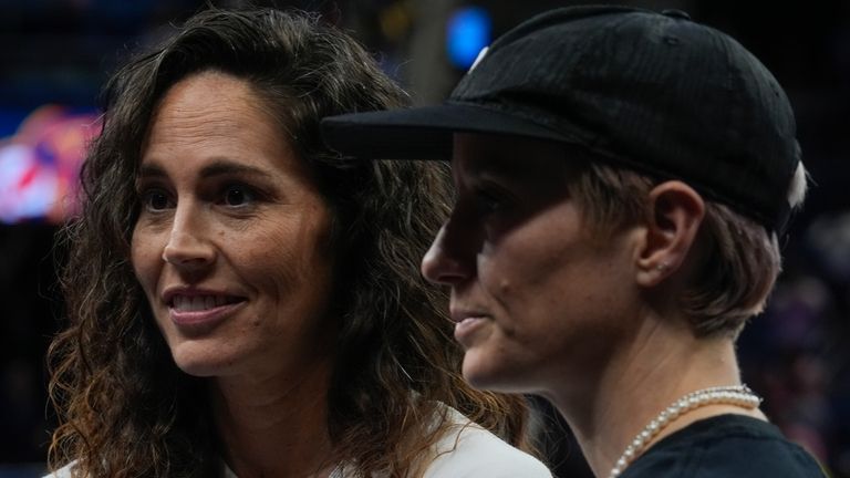 Former Women's National Basketball Association player Sue Bird, left, and...