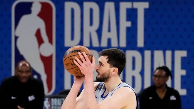 Team St. Andrews' Alex Karaban shoots a free throw during...