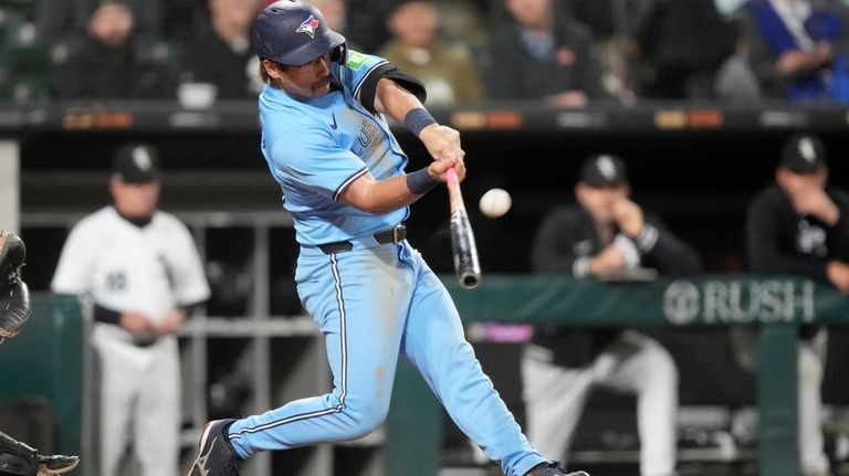 Toronto Blue Jays' Davis Schneider hits an RBI sacrifice fly...