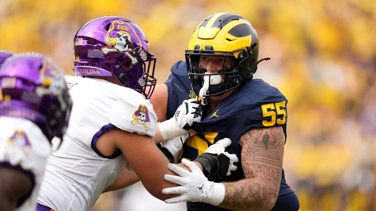 Michigan defensive lineman Mason Graham (55) rushes against East Carolina...