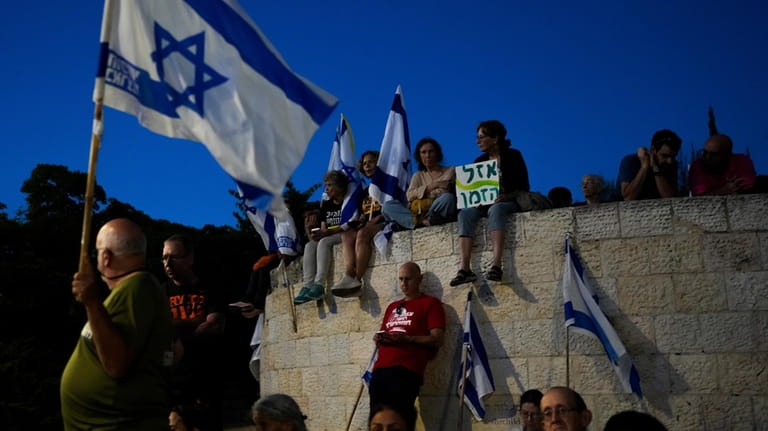 People take part in a protest against Israeli Prime Minister...