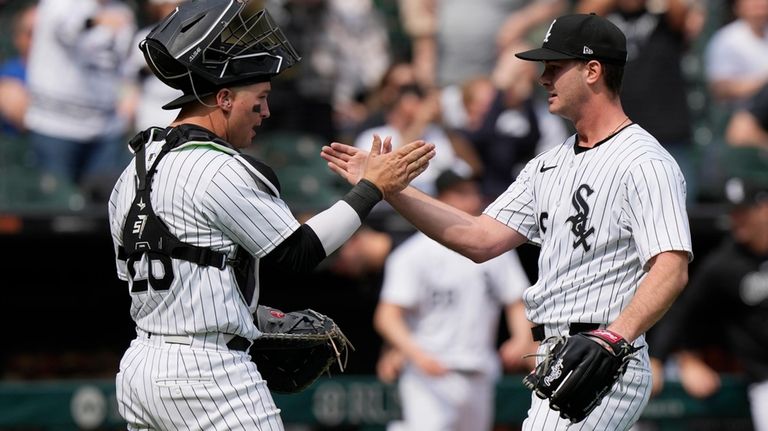 Chicago White Sox catcher Korey Lee, left, celebrates with relief...